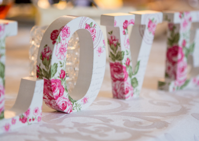 the word love in white and rose lettering