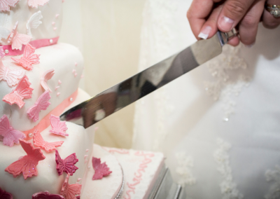 knife cutting wedding cake
