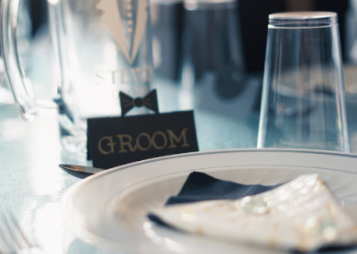 groom place setting at a wedding table with groom sign
