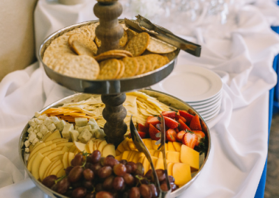 cheese and fruit double tier stand with grapes and cheeses