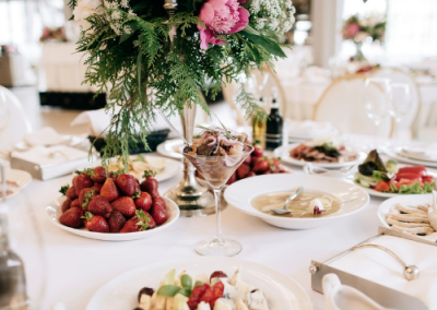 table with flowers and food at a wedding