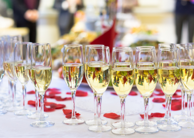 champagne glasses in a v shape filled on a table