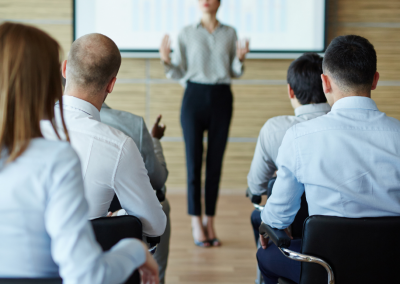 man giving a lecture and people sitting